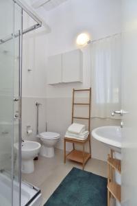 a bathroom with a toilet and a sink and a shower at VILLA FEDERICA CON PISCINA/WITH POOL in Santa Maria Del Focallo