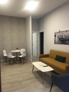 a living room with a couch and a table at Apartamentos La Encarnación III in Los Alcázares