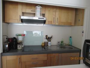 a kitchen with a sink and a microwave at residence Les Canaries in Le Pouliguen
