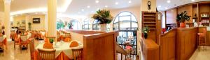 a restaurant with a bar and some tables and chairs at Hotel Residence Villa Beatrice in Brenzone sul Garda
