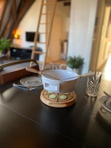 a bowl on a stand on a table at Torenkamer Middelburgh in Middelburg