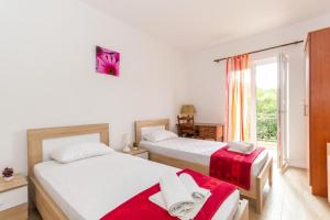 1 dormitorio con 2 camas y ventana en Apartments Forte Mare, en Herceg-Novi