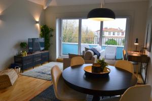 a living room with a table and a couch at Porto Pool Spot in Porto