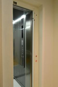 a elevator in a room with a glass door at Porto Pool Spot in Porto