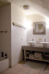 a bathroom with two sinks and a mirror at Hageland Vakantieverblijf in Holsbeek