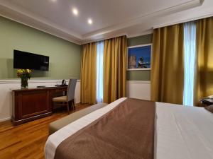 a hotel room with a bed and a desk at Palazzo Turchini in Naples