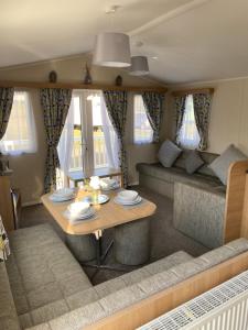 a living room with a table and a couch at Dixons Den Hot Tub in Swarland