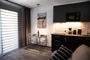 a small kitchen with a table and a counter at Grandes Playas in Corralejo