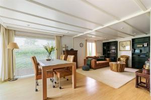 a living room with a table and a couch at Charmant chalet te Voorthuizen in Voorthuizen