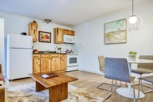 a kitchen with a refrigerator, stove, microwave and a table at Inn at Haystack Rock in Cannon Beach