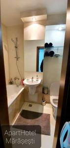 a bathroom with a sink and a toilet and a shower at ApartHotel Marasesti in Suceava +26 photos
