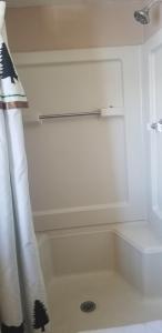 a bathroom with a bath tub with a shower curtain at Columbine Cabins in Grand Lake