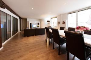 Un comedor con una mesa larga y sillas. en Le Corbeau - Grand Appartement Strasbourg Centre, Calme, en Estrasburgo