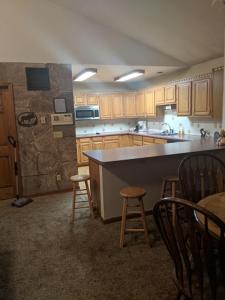 a kitchen with a counter and some stools in it at Columbine Cabins in Grand Lake