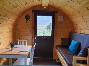 a door in a room with a table and a bench at Gorse Hill Glamping in Newcastle