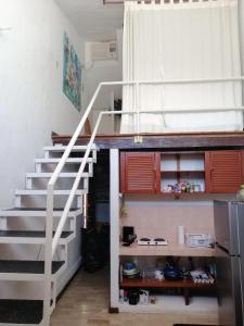a staircase in a small room with a kitchen at Margaritas101 in Cancún