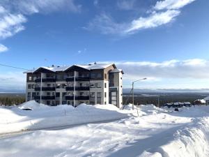 a large building on top of a snow covered mountain at Yllas Chalet VIII 8105 in Ylläs