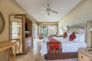 a bedroom with a large bed with a ceiling fan at Villa La Estancia - Medano Beach Villas in Cabo San Lucas +203 photos