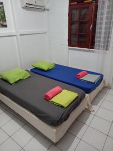 a bed in a room with two pillows on it at LA MAISON DU LAGON in Saint-François