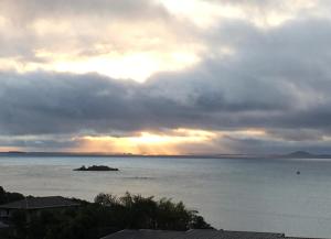 a view of the ocean under a cloudy sky at Doubtless Bay Retreat in Coopers Beach