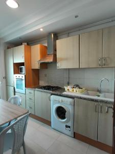 a kitchen with a dishwasher and a sink in it at FLAT JINEN DU LAC 2 in Tunis