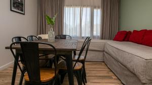 a living room with a table and a couch at Senderos Aparts & Suites in El Chalten
