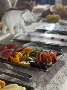 a plate of fruit and vegetables on a table at Beco do Mar Cumbuco in Cumbuco