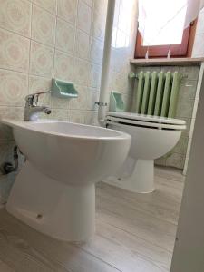 a bathroom with a white toilet and a sink at Trilocale sul Mare in Fano +12 photos