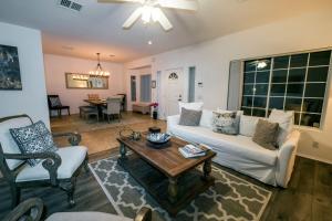 a living room with a couch and a table at Swan House in Palm Springs