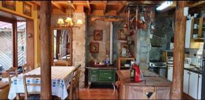 a kitchen with a table and a stove in a room at Casa de Montaña inmersa en Bosque Nativo in San José de Maipo