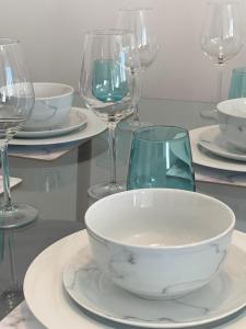 a table with plates and wine glasses on it at Watford Gemini - Eton 1 - Nr Watford Junction, M1 ,M25 in Watford