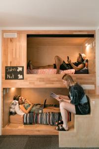 a group of people sitting in bunk beds at Finlay Jack's Backpackers in Taupo