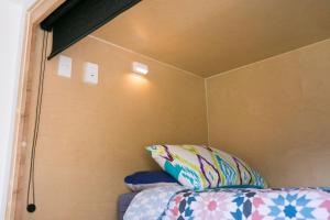 a room with a bed with a pillow on it at Finlay Jack's Backpackers in Taupo