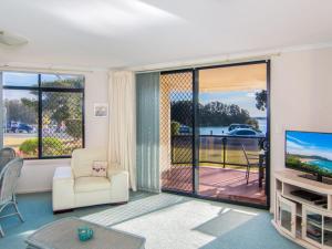 a living room with a large sliding glass door at Horizons 1 in Forster