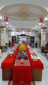 a long table with red table cloths in a room at Phuc Ngoc Hotel in Ap Rạch Soi