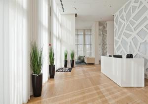 a lobby with potted plants and a reception desk at Oַ&O Group- Luxury Penthouse Jacuzzi Sea 36 Floor in Bat Yam
