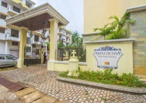 a building with a sign on the side of it at Areia De Goa - Sunrise By Leela Homes in Arpora