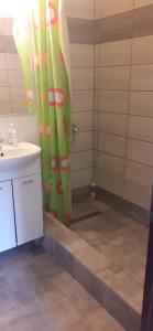 a bathroom with a shower curtain and a sink at Apartament 2 cam Predeal in Predeal +35 photos