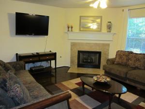 a living room with a couch and a fireplace at Relaxing 4 Bedroom Home in Conroe