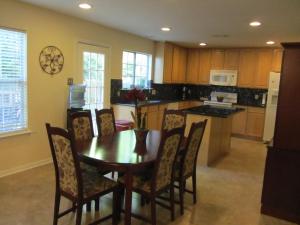 a kitchen with a wooden table and chairs and a kitchen with a counter at Relaxing 4 Bedroom Home in Conroe