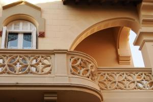 a balcony of a building with a window at Hotel El Xalet in Sitges