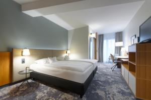 Säng eller sängar i ett rum på Hotel am Kloster
