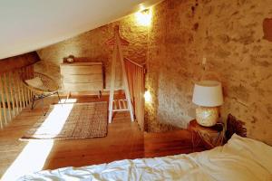 a bedroom with a bed and a table with a lamp at GITE AU COEUR DE LA CAMPAGNE in Saint-Sève