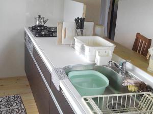 a kitchen with a sink with a bowl in it at Guest House Miyakojima in Miyako-jima +37 photos