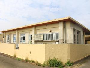 a house with a fence in front of it at Guest House Miyakojima in Miyako-jima