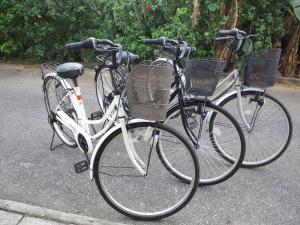 two bikes parked next to each other on a street at Guest House Miyakojima in Miyako Island