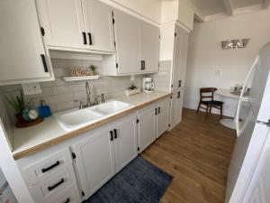a kitchen with white cabinets and a sink at Center Street Villas in Joshua Tree