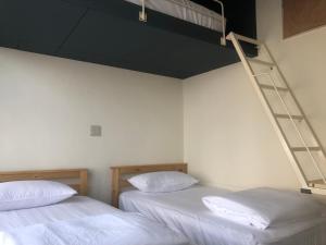 Uma cama ou camas num quarto em Simple Walk Guest House 小公寓