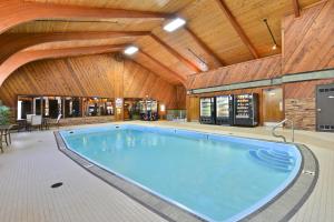 a large swimming pool in a building with a wooden ceiling at Super 8 by Wyndham Deadwood Black Hills Area in Deadwood
