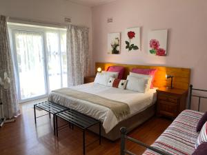 a bedroom with a large bed and a window at Little Acres Drakensberg Accommodation in Champagne Valley